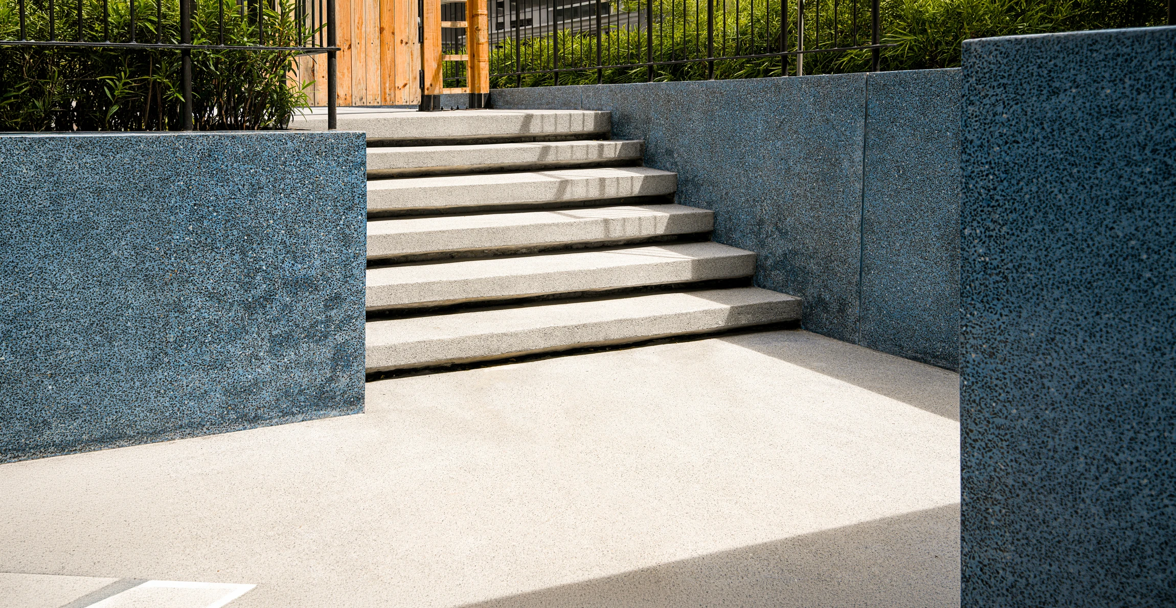 Escalier extérieur en pierre naturelle calcaire avec marches massives, intégré dans jardin paysager méditerranéen